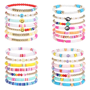 Detail view of colorful bohemian multi-layered beaded bracelets with mixed charms