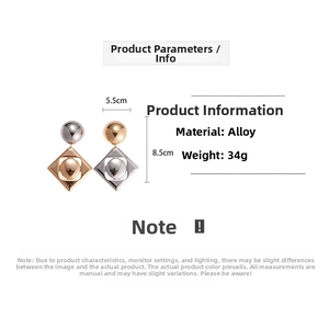 Macro detail of geometric mixed metal earrings showing 5.5cm width and 8.5cm height
