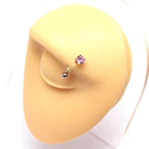 Minimalist stainless steel eyebrow piercing ring with pink zircon on silicone eye model