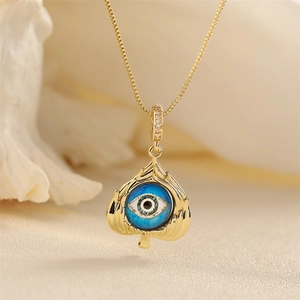 Exquisite gold leaf pendant necklace featuring a blue Devil's Eye and sparkling accents