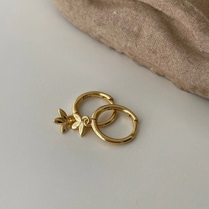 Close-up of S925 sterling silver gold hoop earrings with delicate leaf charms