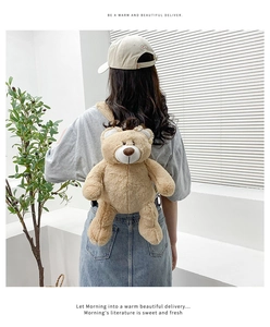 Rear view of a soft brown plush bear backpack worn by a model in a bright room