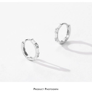 Detailed macro shot of S925 sterling silver hoop earrings with zircon and bamboo design