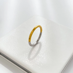 Detail shot of two-tone stainless steel ring with polished gold and silver contrast