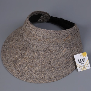 Close-up of gray woven sun hat with UV protection tag and elastic strap detail