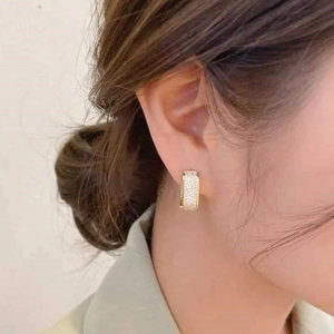 Elegant gold U-shaped hoop earrings with sparkling micro-pave cubic zirconia crystals