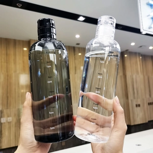 Detailed view of clear and black transparent water bottles with printed time markers