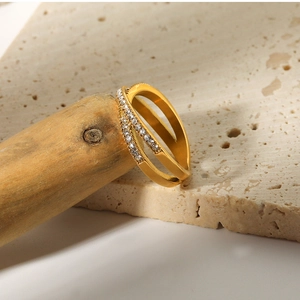 Detail view of a double-layered gold ring featuring a polished band and micro-pave zircons