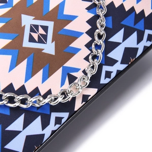 Detail of bohemian fabric pattern with silver chain strap on a shoulder bag