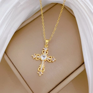 Detailed close-up of a gold titanium necklace with a sparkling diamond-set cross pendant