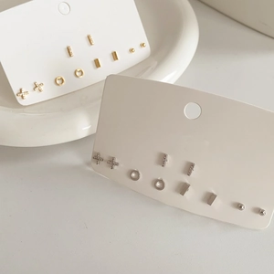 Macro detail of gold and silver plated geometric stud earring sets on display cards