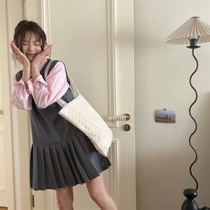 Close-up of white lace mesh flower tote bag paired with pink shirt and pleated dress