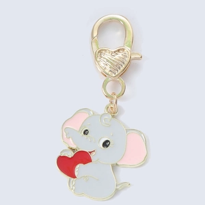 Macro detail of cute grey enamel elephant pendant with heart lobster clasp keychain