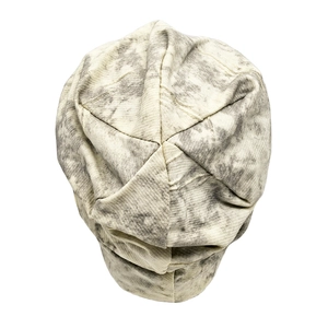 Detail of the hexagonal stitched top on a grey marble pattern knitted slouchy beanie