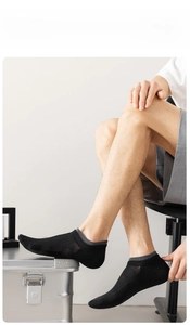 Detail of men's breathable low cut socks in black cotton with grey mesh texture