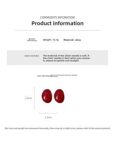 Detail view of red oval stud earrings showing dimensions 2.6cm by 1.8cm and silver pins