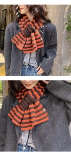 Close-up of orange and brown striped keyhole knit scarf with small leather detail