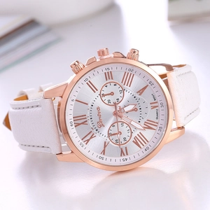 Detail view of white leather strap watch with rose gold case and Roman numeral dial