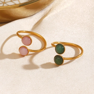 Minimalist gold open rings featuring polished pink and green round gemstones on satin