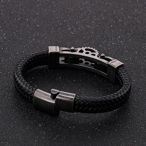 Detail of industrial men's braided leather bracelet with vintage steel gear buckle
