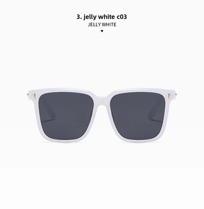 Detail view of jelly white oversized square sunglasses with gold accents and dark lenses