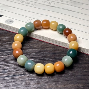 Close-up of colorful gemstone prayer beads on an ancient book with Chinese calligraphy