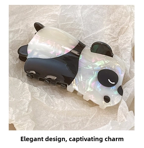 Close-up of cute panda hair claw clip with pearlescent finish on white paper