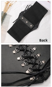 Close-up of black elastic wide waist belt with lace-up leather front and snap buttons