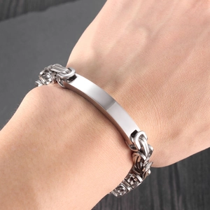 Silver Byzantine chain bracelet with curved rectangular plate on a male wrist detail