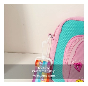 Detail of the durable plastic lobster clasp and rainbow star strap on unicorn bag