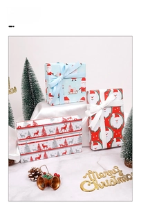Three rolls of Christmas kraft gift wrapping paper with reindeer and Santa Claus patterns