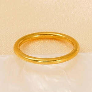 Close-up of minimalist 18k gold plated stainless steel ring on a pearl base