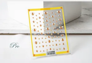 Macro view of 5D embroidery bee nail stickers with golden floral patterns TS-058