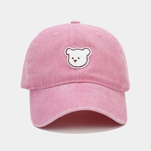 Close-up of pink washed cotton baseball cap with cute white bear embroidery detail