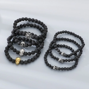 Lava stone bead bracelets with metal skull and cross charms in dark gothic punk style