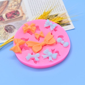 Pink round silicone mold for bow shaped cake decorations and fondant chocolate making