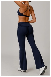 Rear view of navy blue high-waist flared yoga pants and cross-back sports bra set