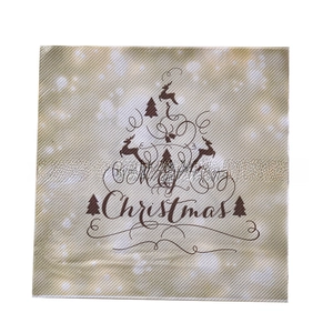 Close-up of beige Christmas napkins with Merry Christmas text and reindeer tree pattern