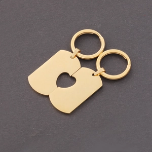 Detail of two gold stainless steel interlocking heart tag keychains for couples