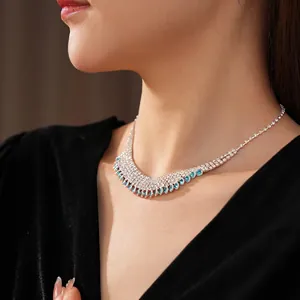 Luxurious silver tassel necklace featuring sky blue teardrop gems and rows of small diamonds