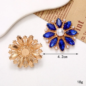Golden flower brooch with blue marquise stones and white pearls, 4.2cm diameter
