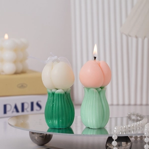 Creative tulip scented candles in pink and cream colors with green leaf bases