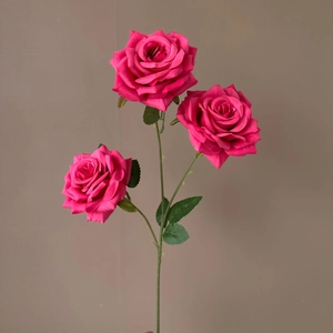 Detailed view of artificial 3-head rose bouquet in magenta with green leaves and stems