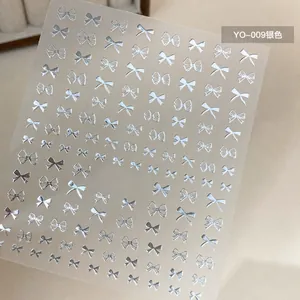 Macro shot of silver bowknot nail stickers YO-009 with metallic finish for nail art decor
