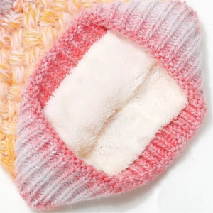 Close-up of gradient knit beanie with thick white faux shearling lining for winter warmth