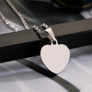 Close-up of a polished heart pendant on a rope chain featuring a mirror-like finish