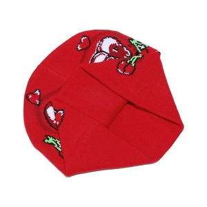 Detail showing the red knitted texture and heart patterns of the warm winter beanie
