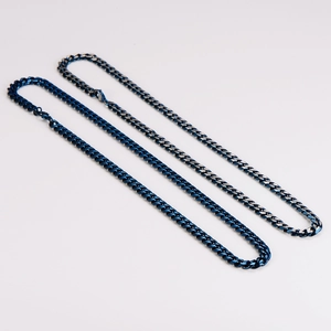 Close-up of silver and deep blue minimalist cuban link chains with a polished finish