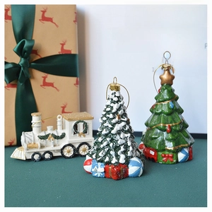 Festive Christmas table decor featuring miniature white train and snow-dusted green pine trees