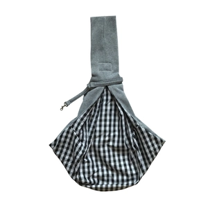 Detail of the grey pet sling carrier with checkered lining and silver safety hook